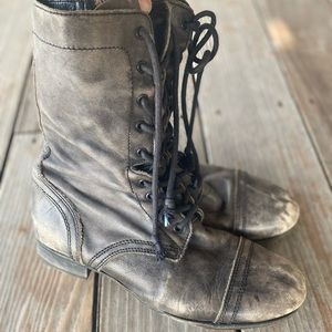 Black combat boots by All Saints.